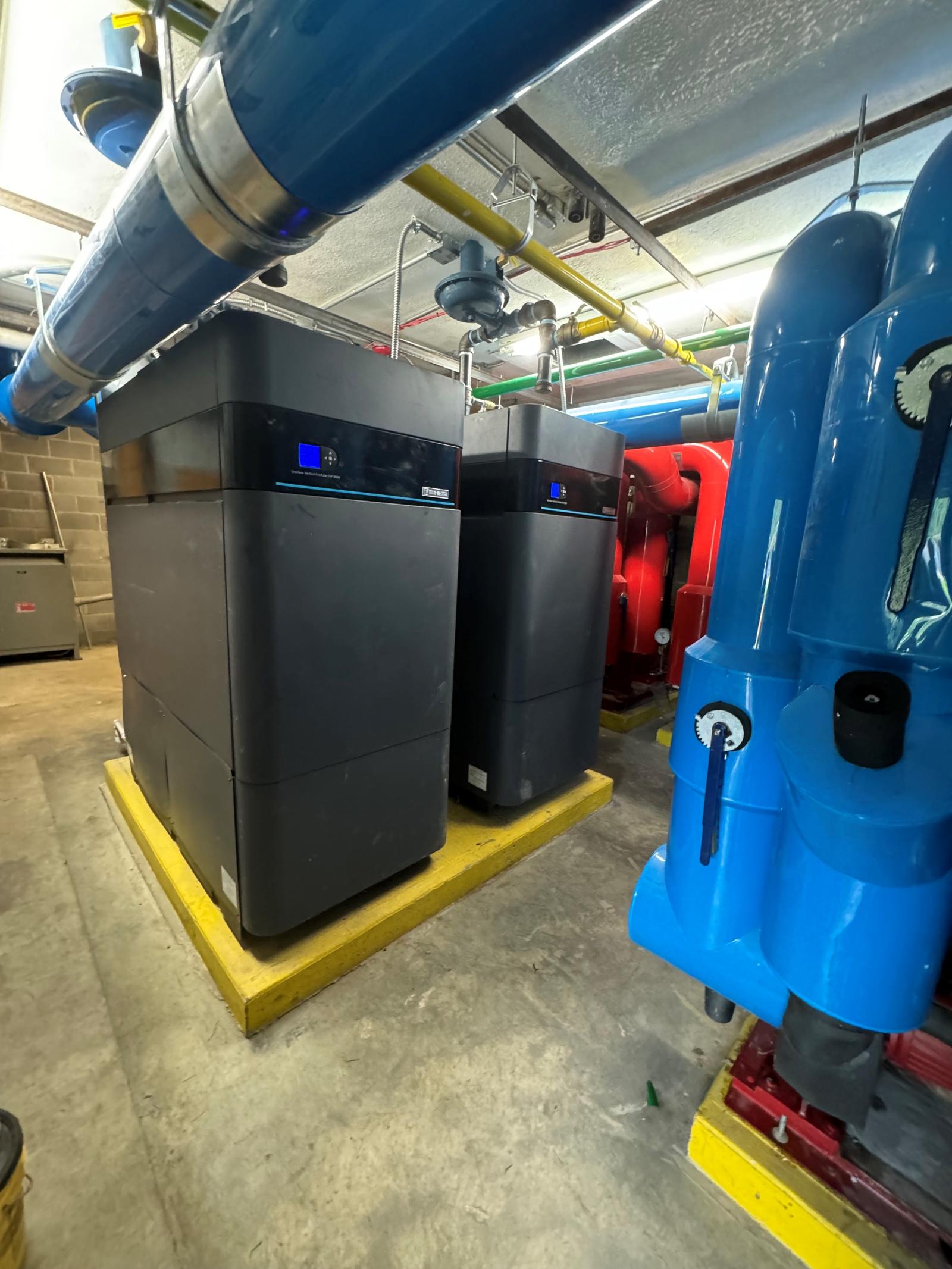 Boiler feedwater tanks and piping in a commercial mechanical room