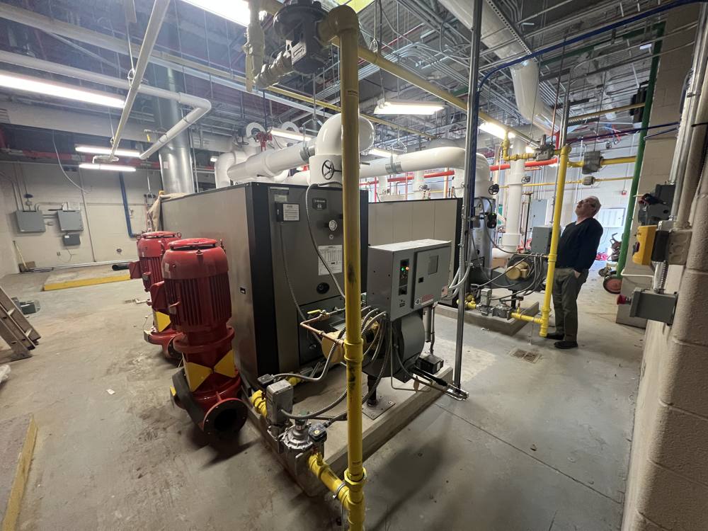 RK Hunter technician troubleshooting a commercial boiler in a mechanical room