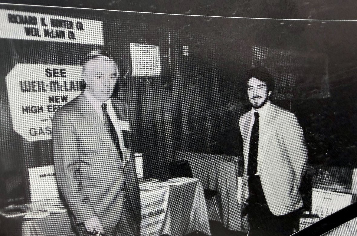 Jim Gilliam and a young Clarke Gilliam at a Richard K. Hunter Co. and Weil-McLain trade display, circa 1980